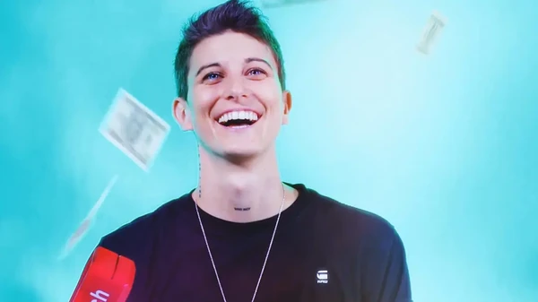 A man in Princess Charming Season 2 laughs joyfully as money flies around him.